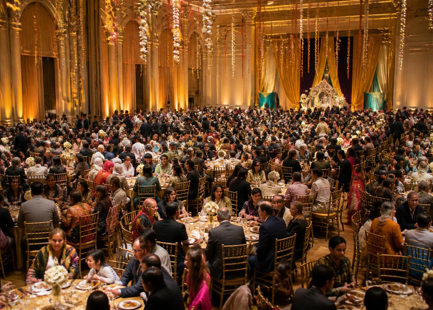 Grand hall filled with hundreds of guests at round tables during a large community celebration